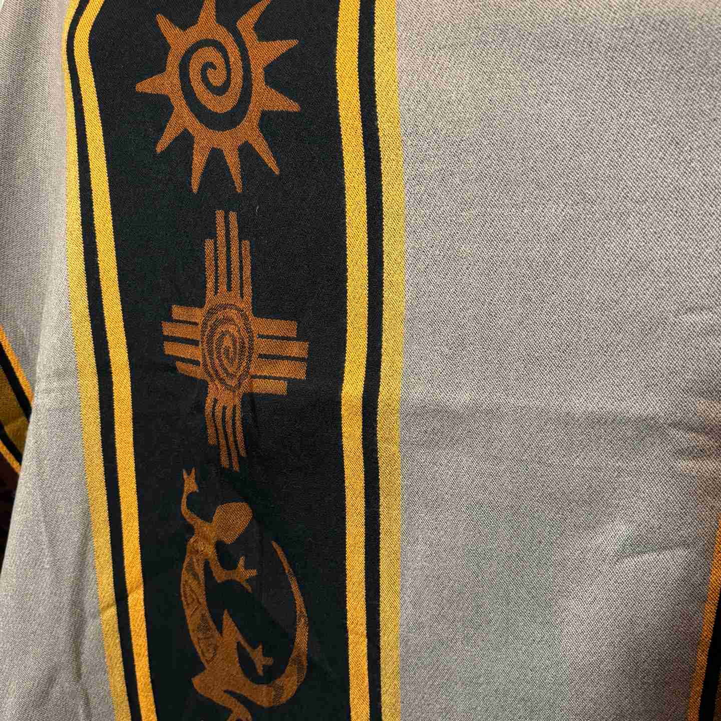 Four Directions Nightfall hooded alpaca-blend poncho in taupe and black, front view with sun and four-directions motif