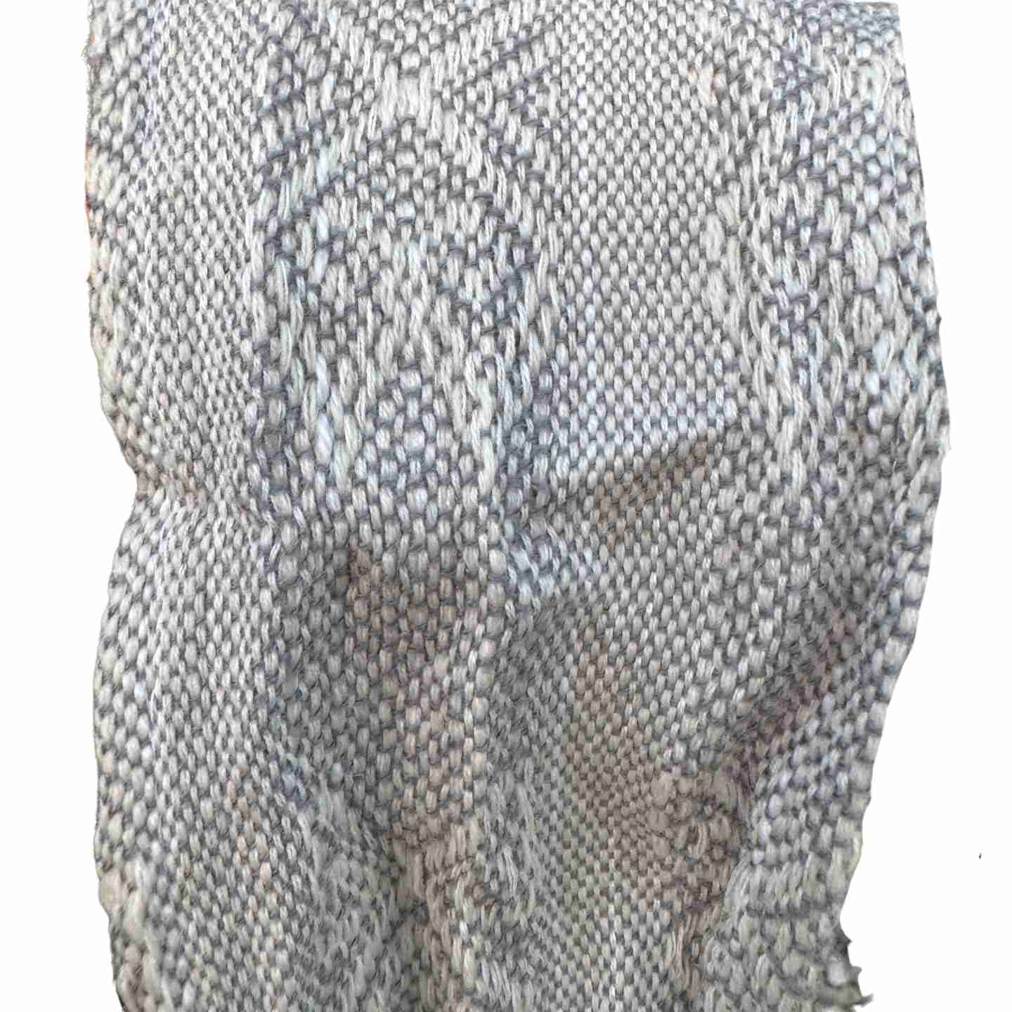 Textured fabric swatch in gray and white on a white background